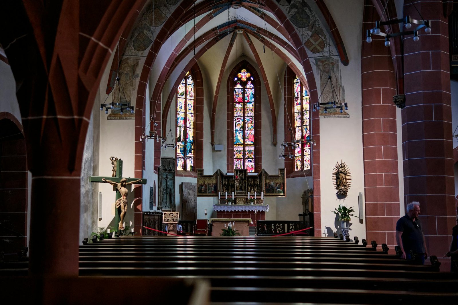 A church with stained glass windows and pews